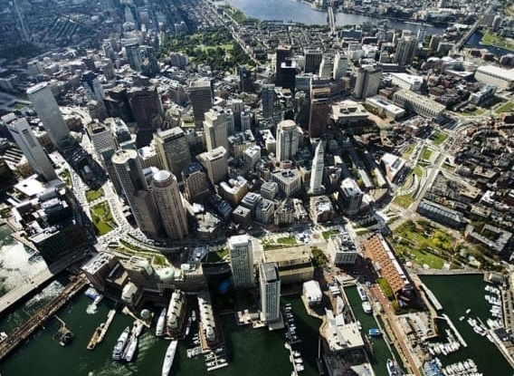 a aerial photo of a city surrounded by a body of water