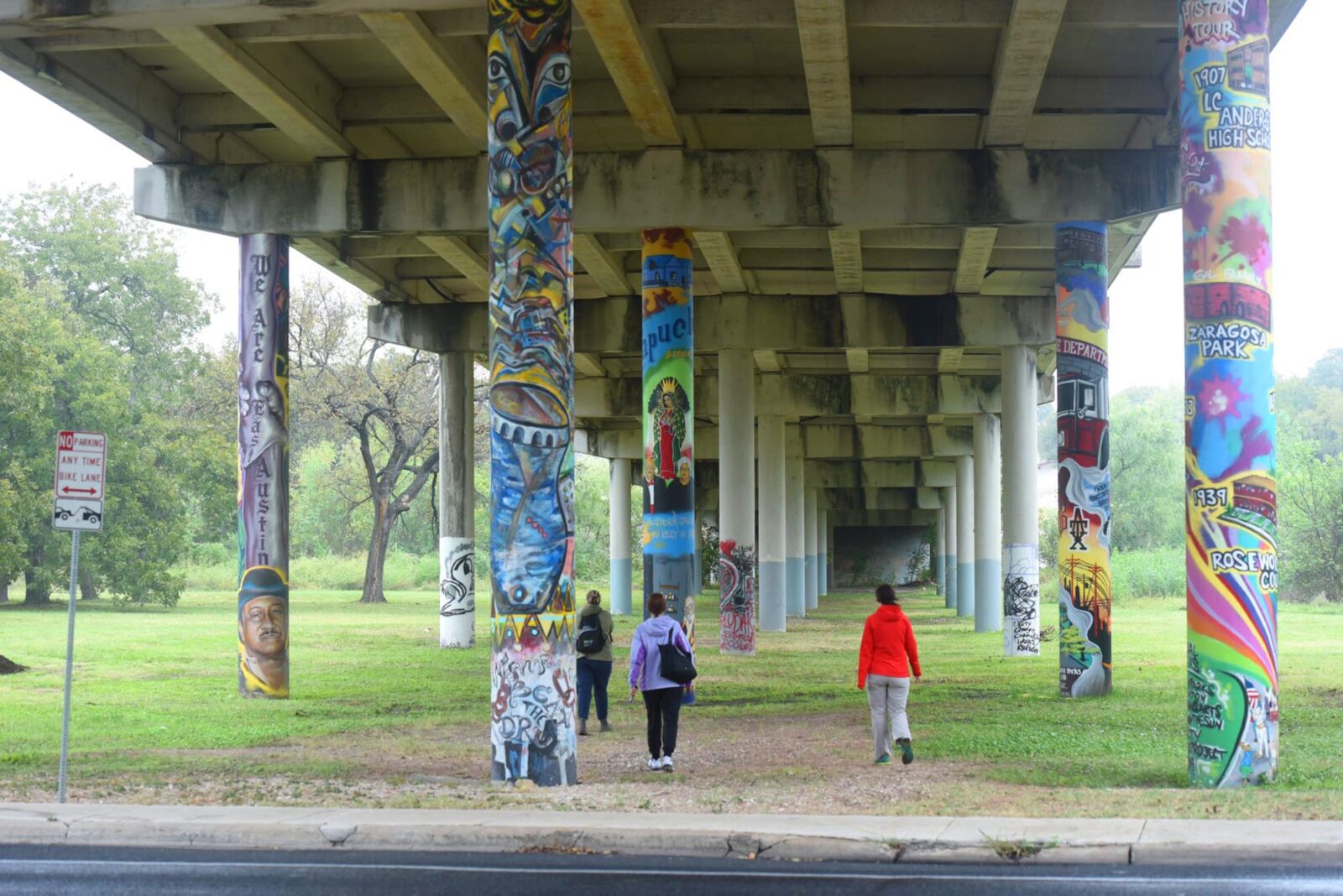 Park Study Tour attendees exploring green space under a highway