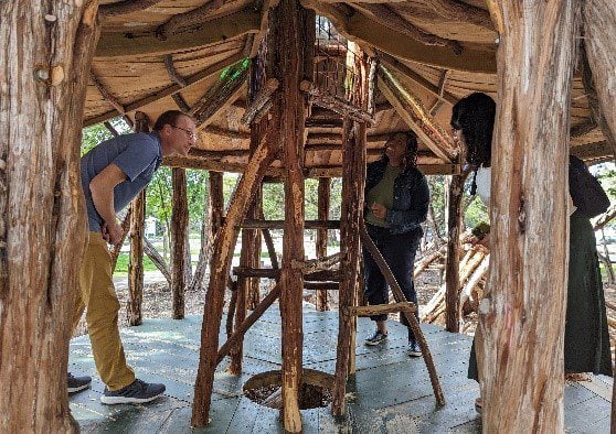 Park Study Tour attendees investigating a natural tree house