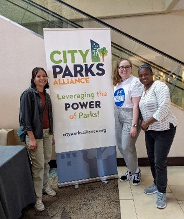 Park Study Tour attendees posing at a City Parks Alliance banner