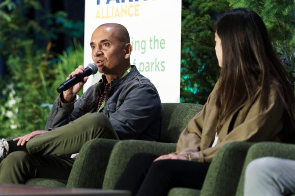 A man and a woman on stage at Greater & Greener 2024 presenting at a panel discussion