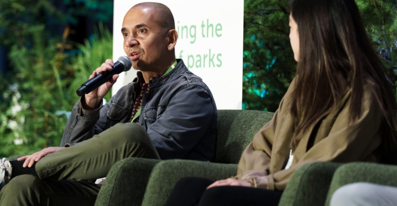 A man and a woman on stage at Greater & Greener 2024 presenting at a panel discussion