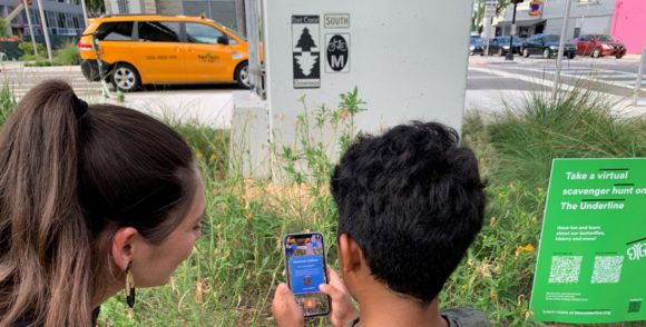 A mother and child looking at their phone at the Underline in Miami