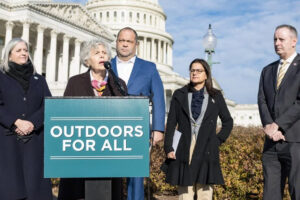 A group of professionals standing behind a podium in front of the U.S. Capitol building