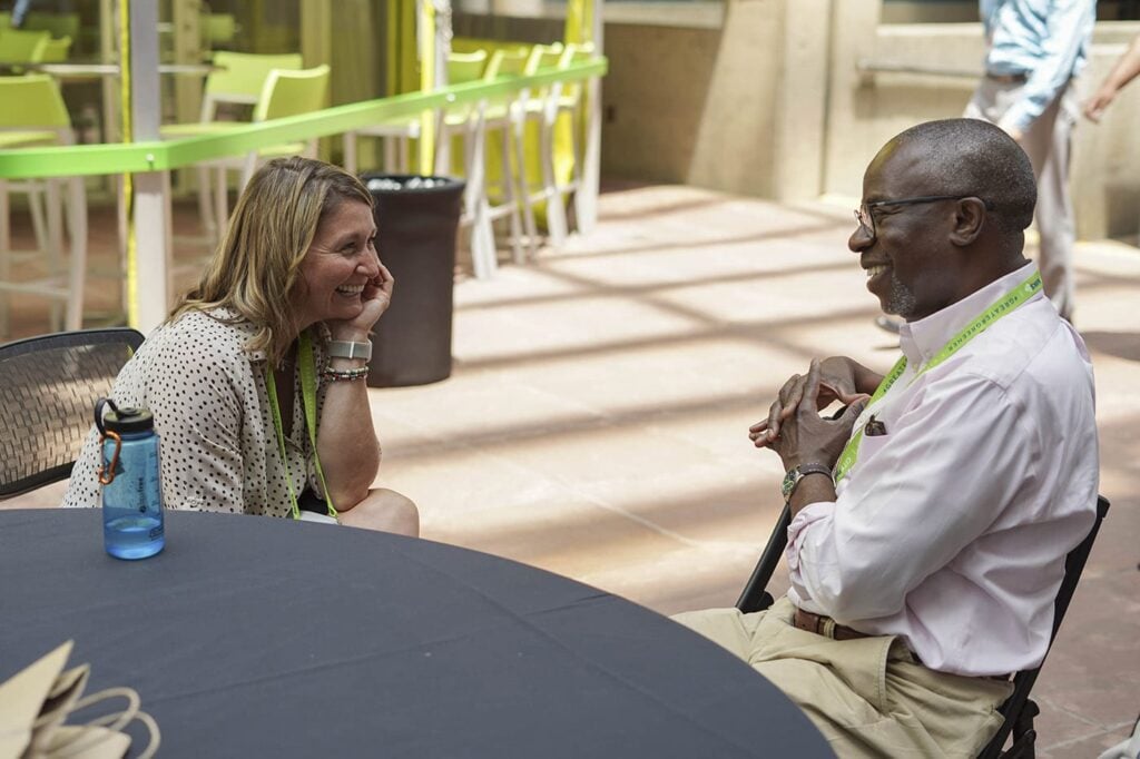 Two people talking at Greater & Greener in Denver.