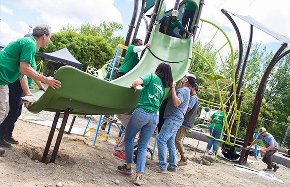 Volunteers building a playground at TT Minor park in Seattle as part of Greater & Greener Volunteer Service Day.