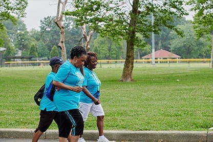 A group of women walking in a park.