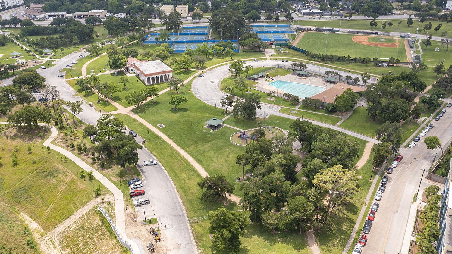 A park from overhead showing trees, a pool, tennis courts, baseball field, parking, and a pavillion