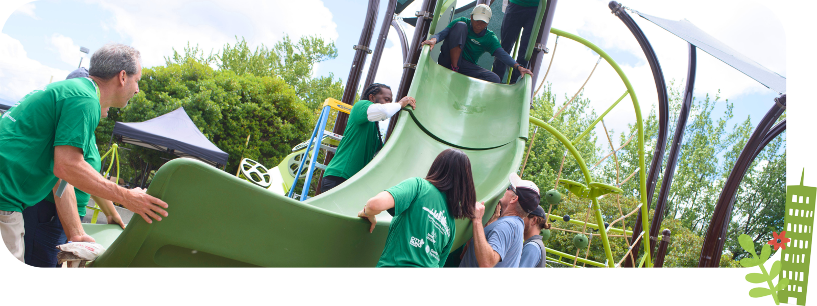A group of volunteers lifting a slide to be secured into place