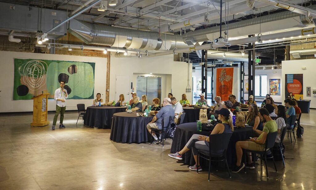 A group of people looking on at a presentation