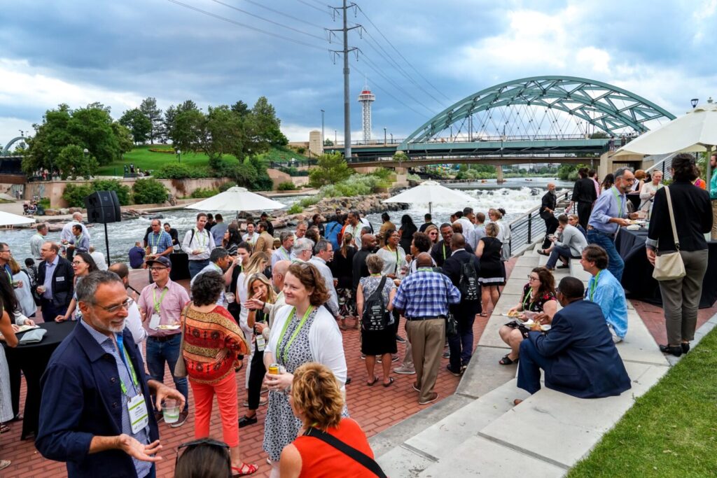 A large group mingling at an outdoor plaza
