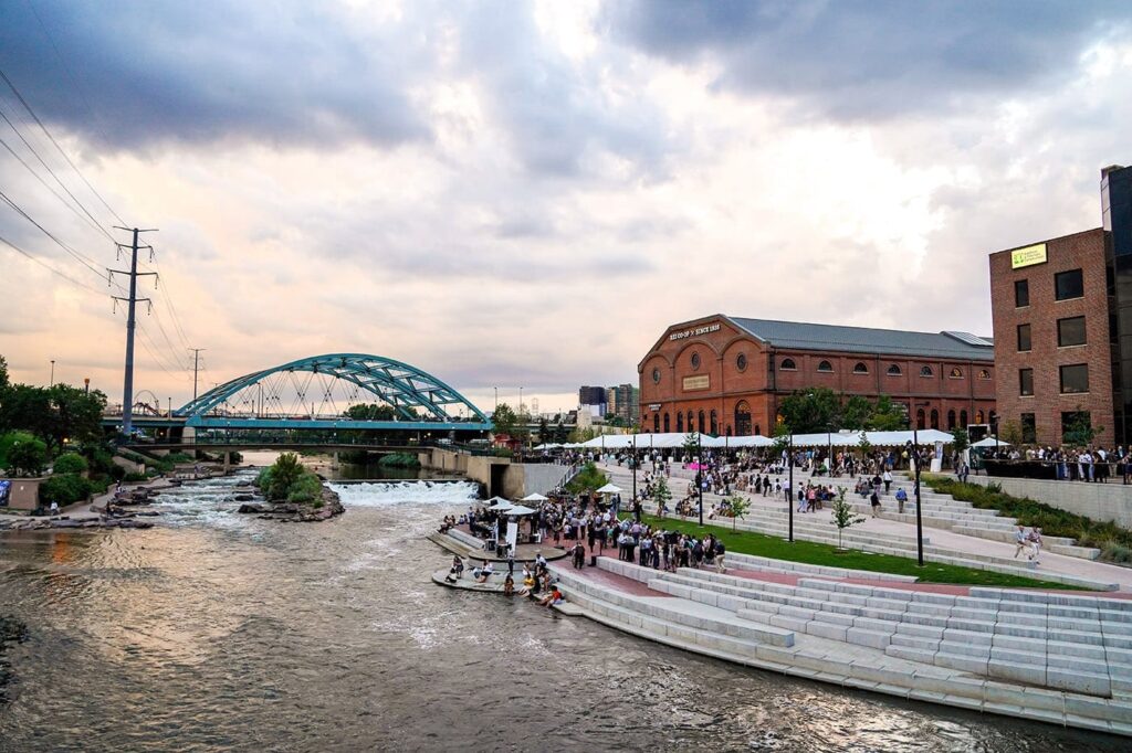 A bridge, river, buildings, and outdoor plaza