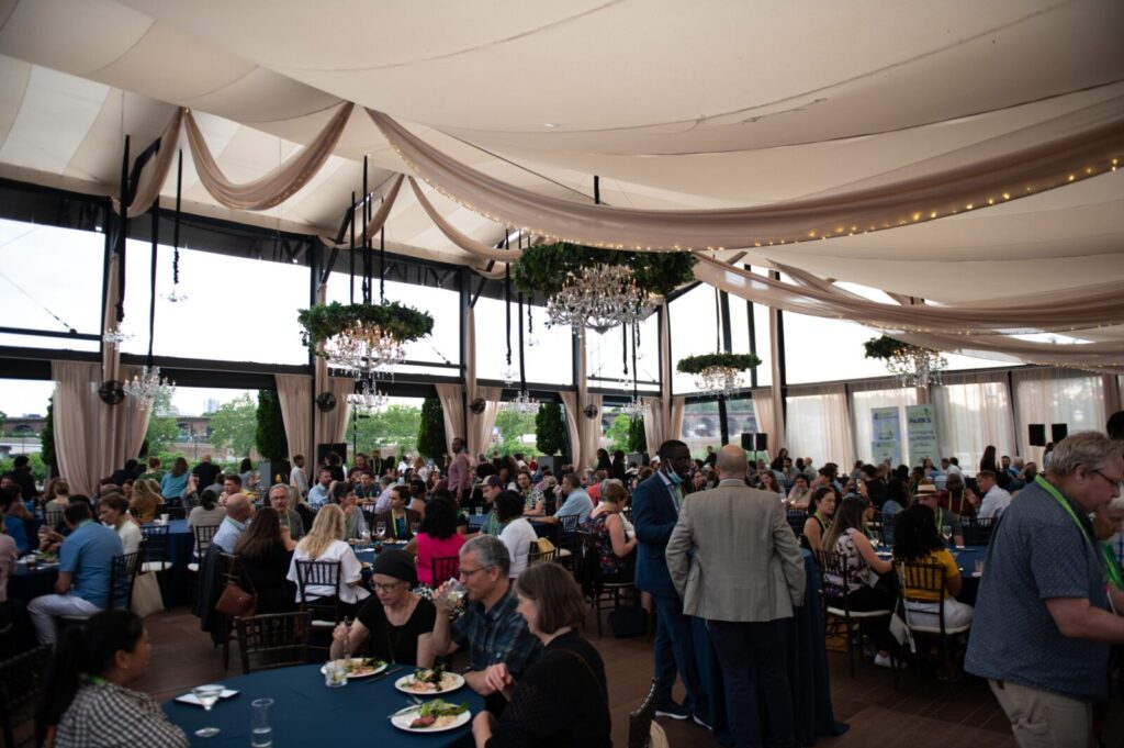 A crowd sitting and eating at a reception