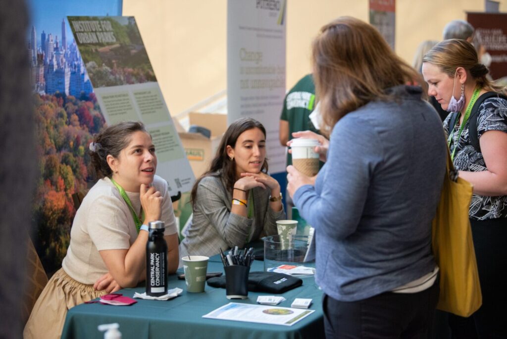 An exhibitor speaking to a visitor