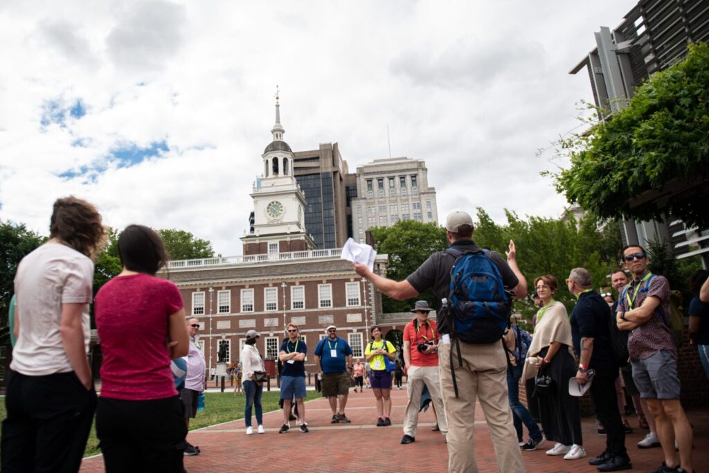 A guide speaking to a tour group in front of Independence Hall