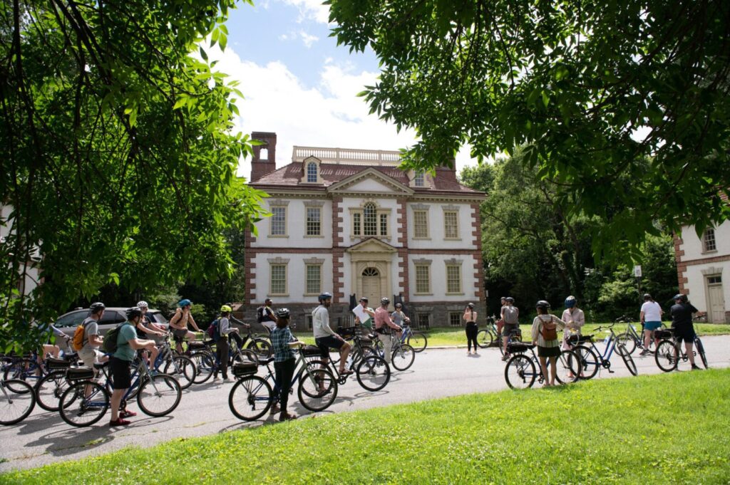 A group of bike riders outside an historical building