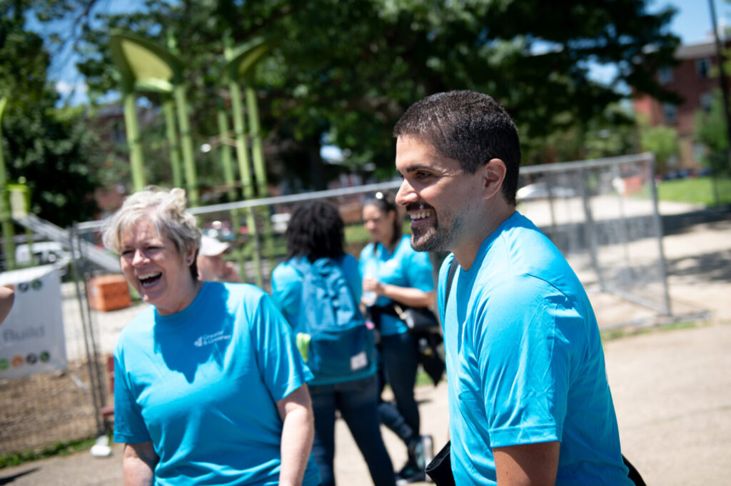 A man and woman laughing at a playground