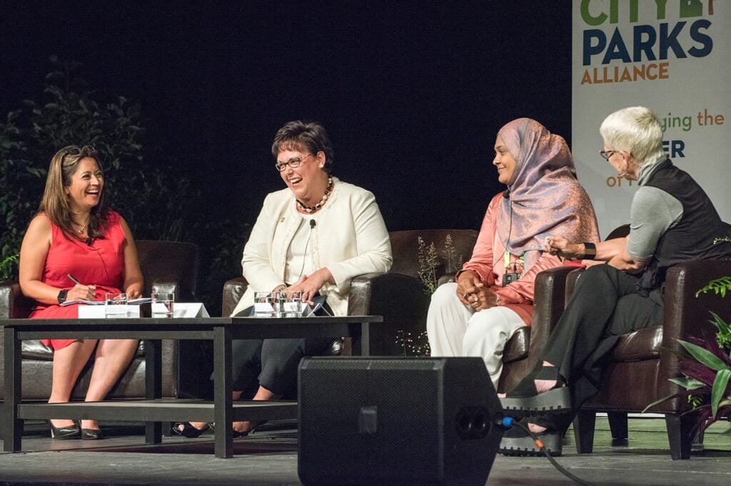Four women on stage in discussion