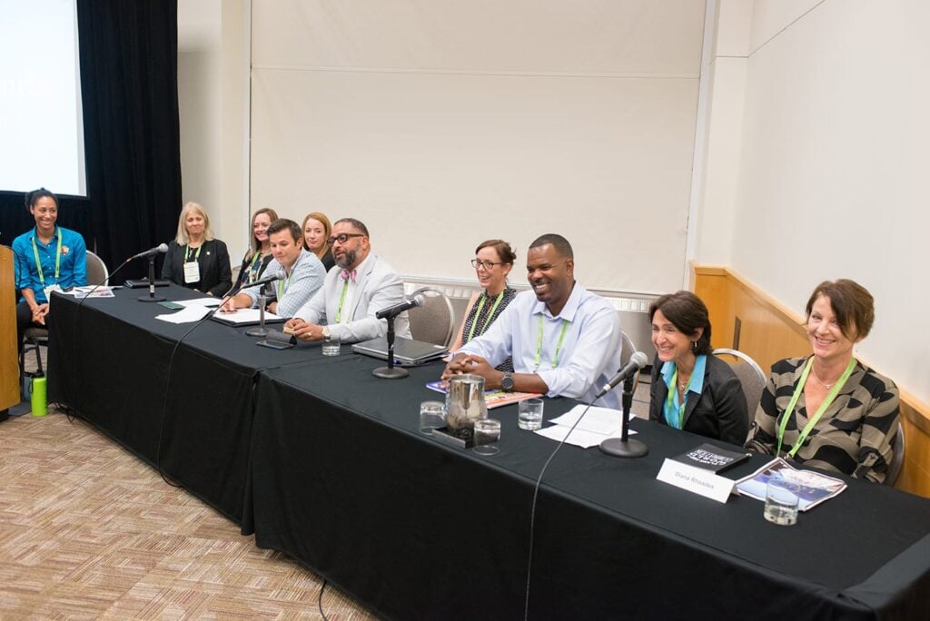 A long table of panel presenters