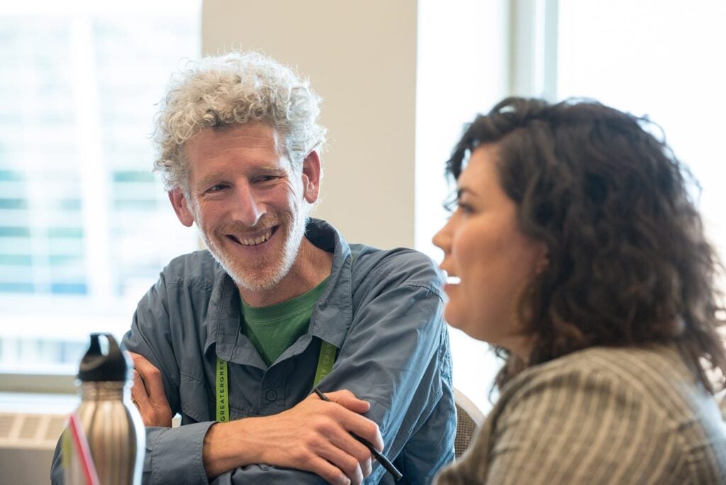 A man smiling at a woman