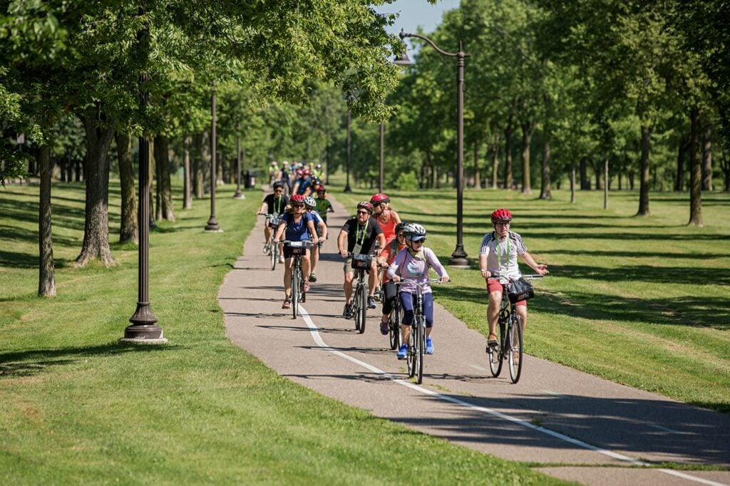 A group bike riding down a paved path