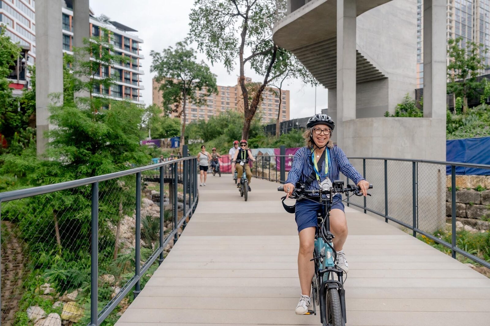 Bike riders cycling down a walkway