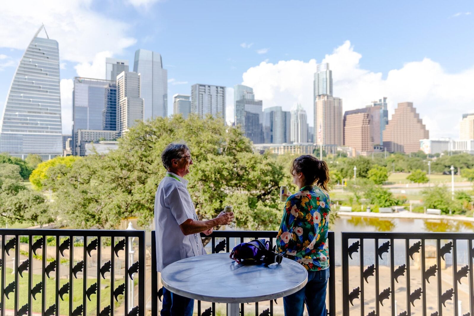Two people speaking in front of the Austin skyline