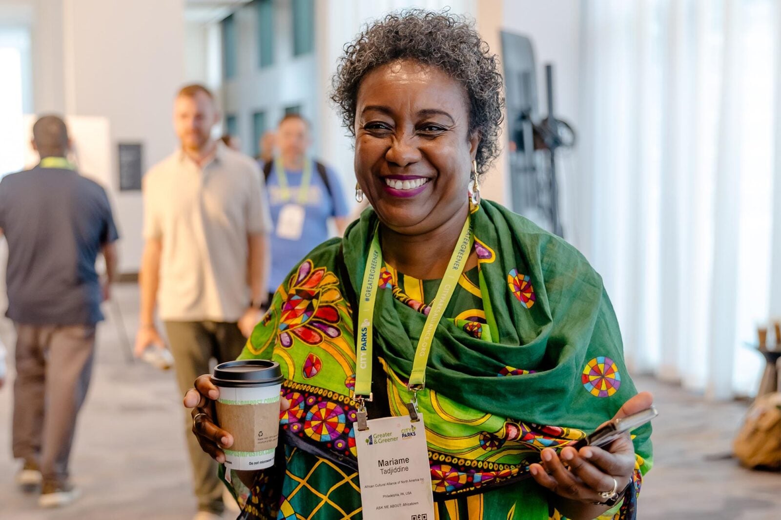 A woman in bright green clothing smiling