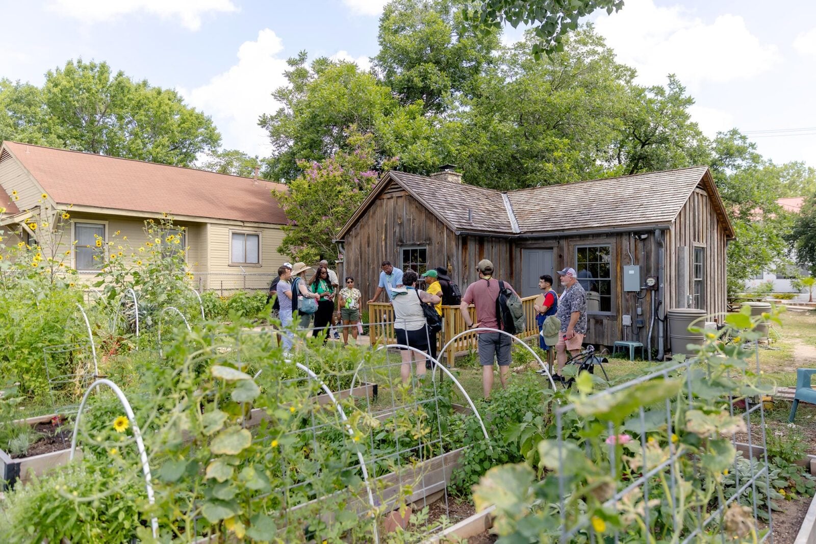 A group of Greater & Greener attendees in a garden
