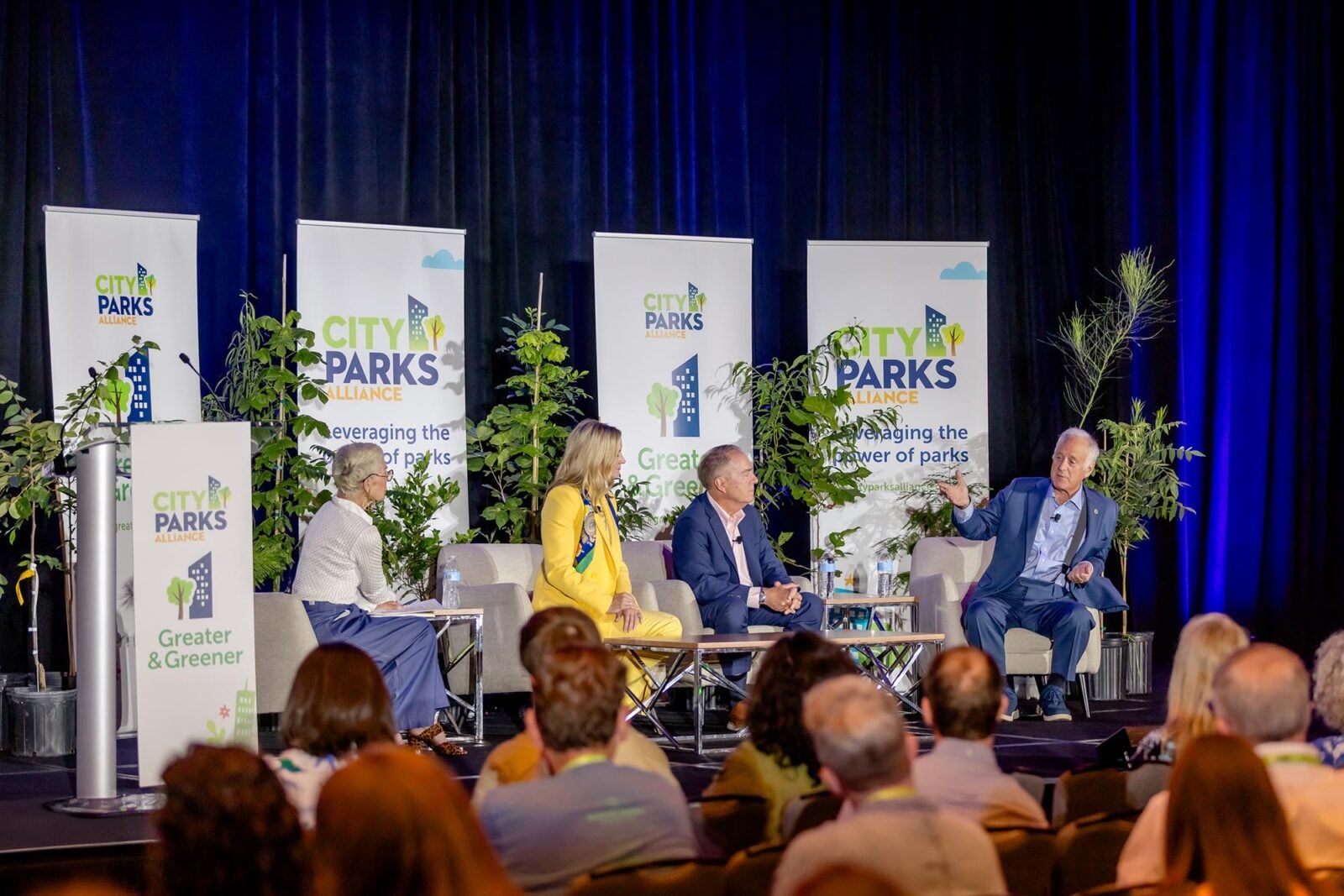 Four professionals on stage at the Greater & Greener Mayors Forum