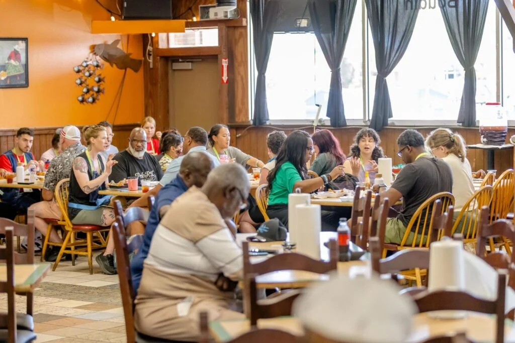 A group of Greater & Greener attendees eating in a food hall