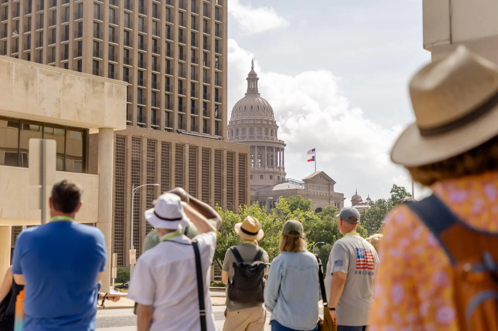 A tour group looking onto the Texas State Capitol building in Austin