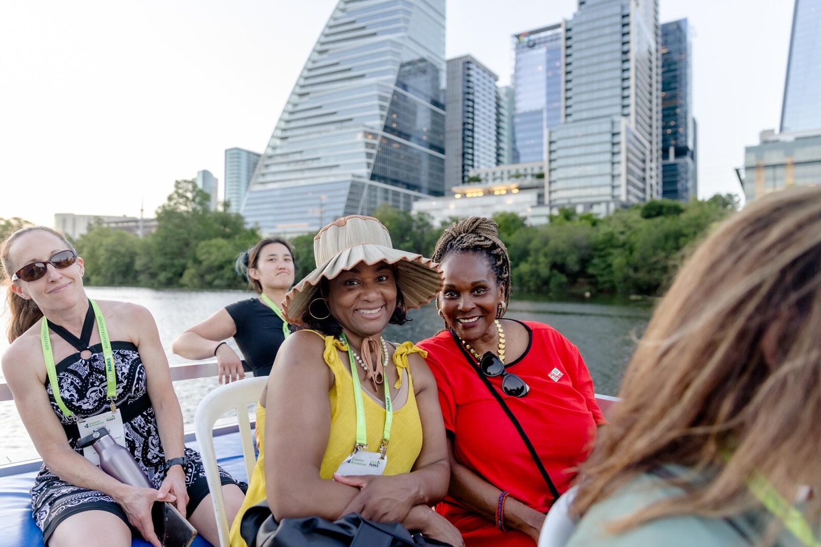 Women on a boat in front of the Austin skyline