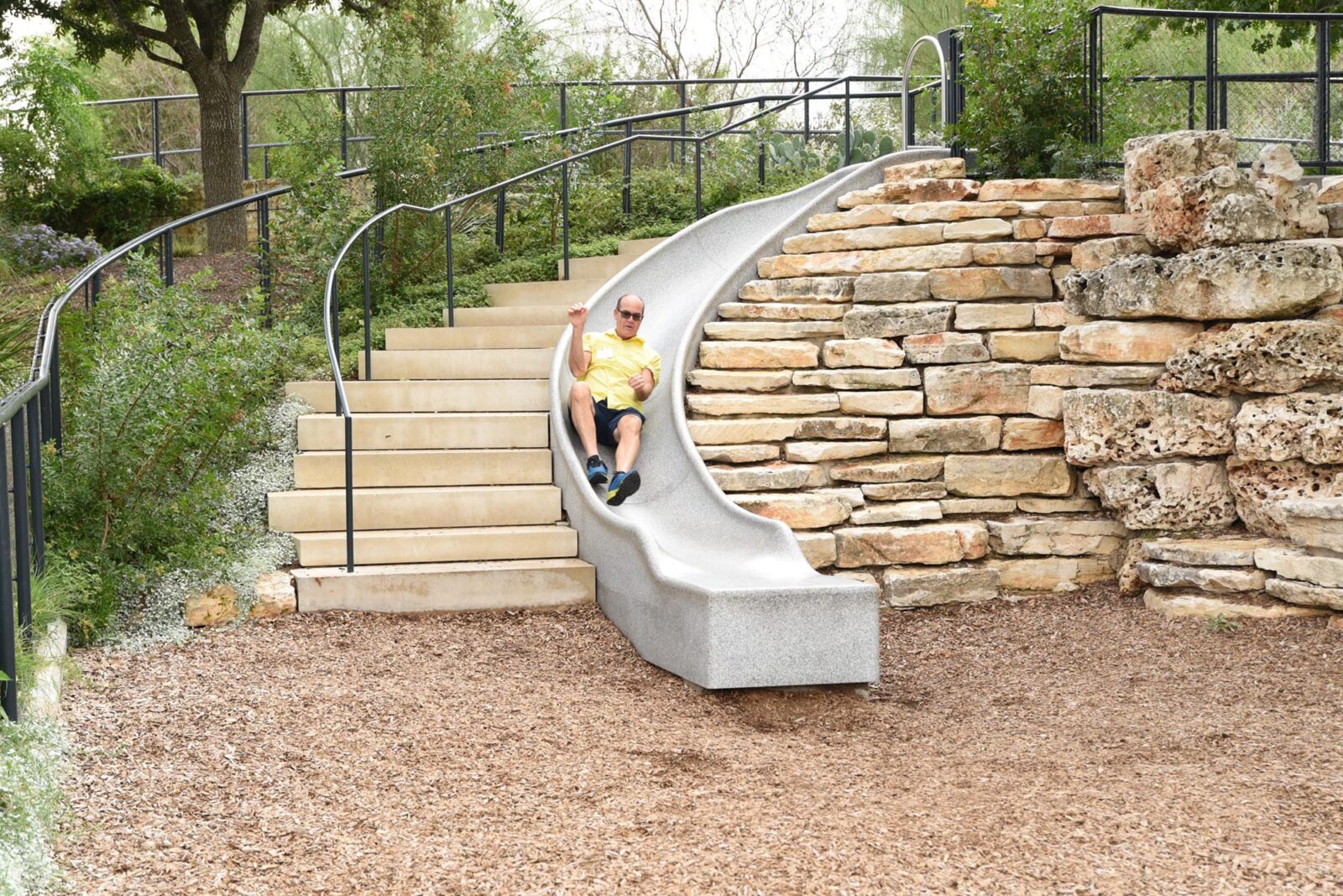 A Park Study Tour attendee going down a slide