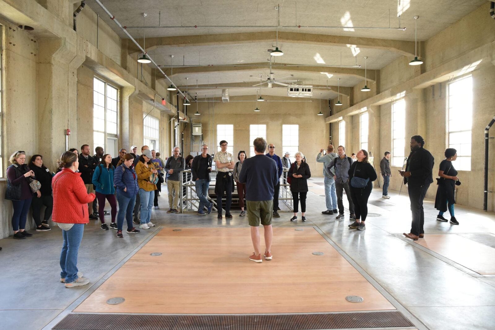A group listening to a tour leader in an atrium