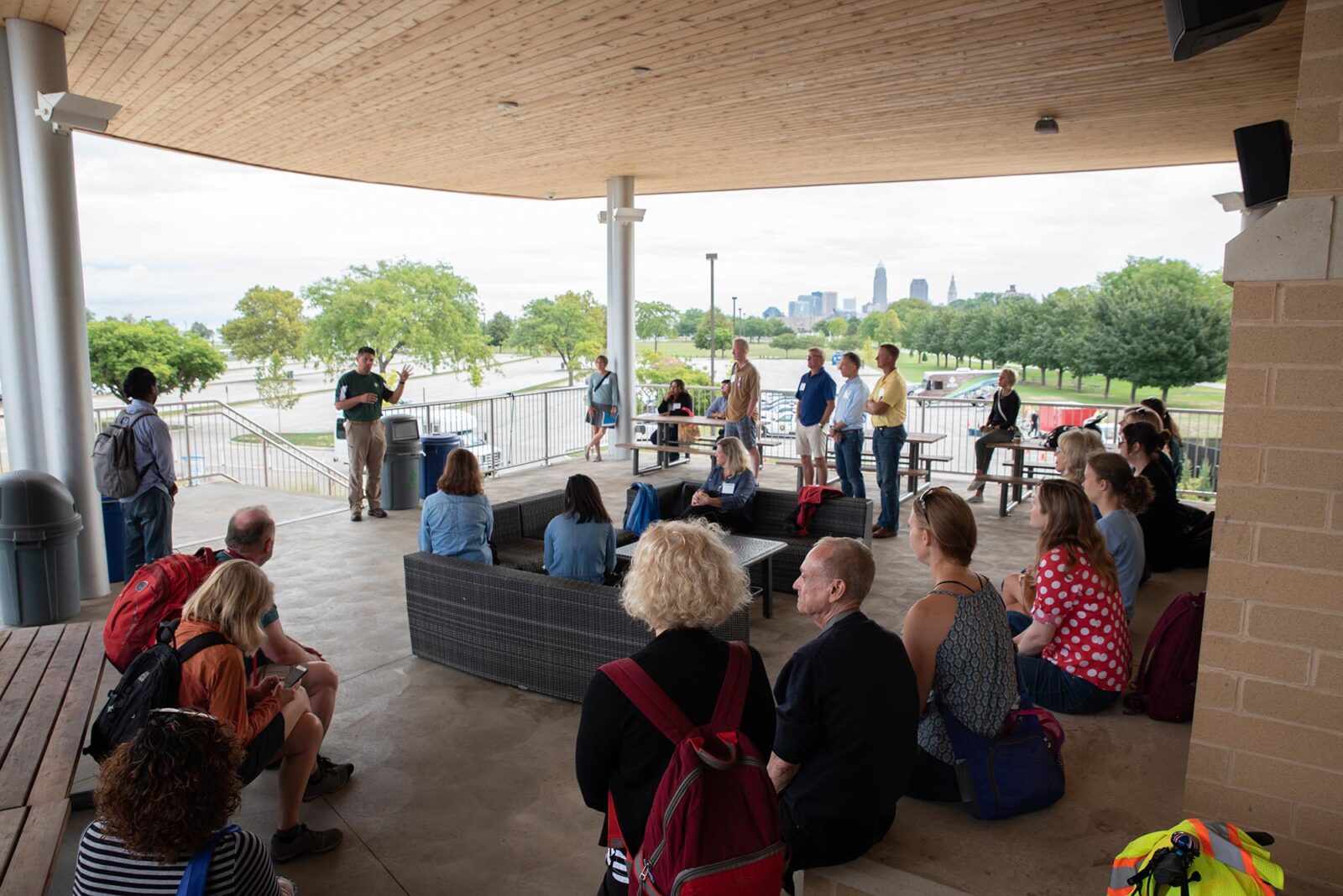 Park Study Tour attendees listening to a tour leader in front of the Cleveland skyline