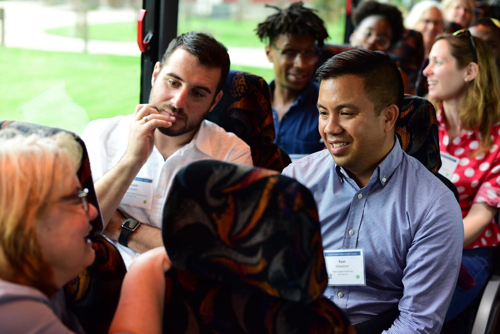 Park Study Tour attendees in conversation on a bus