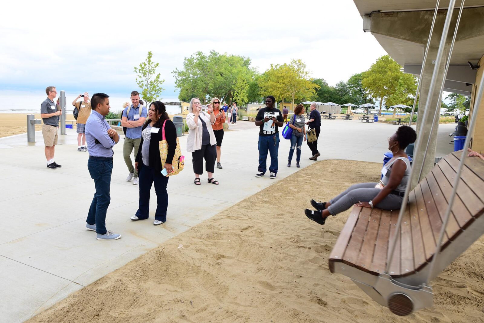A Park Study Tour attendee on a swing as other attendees look on