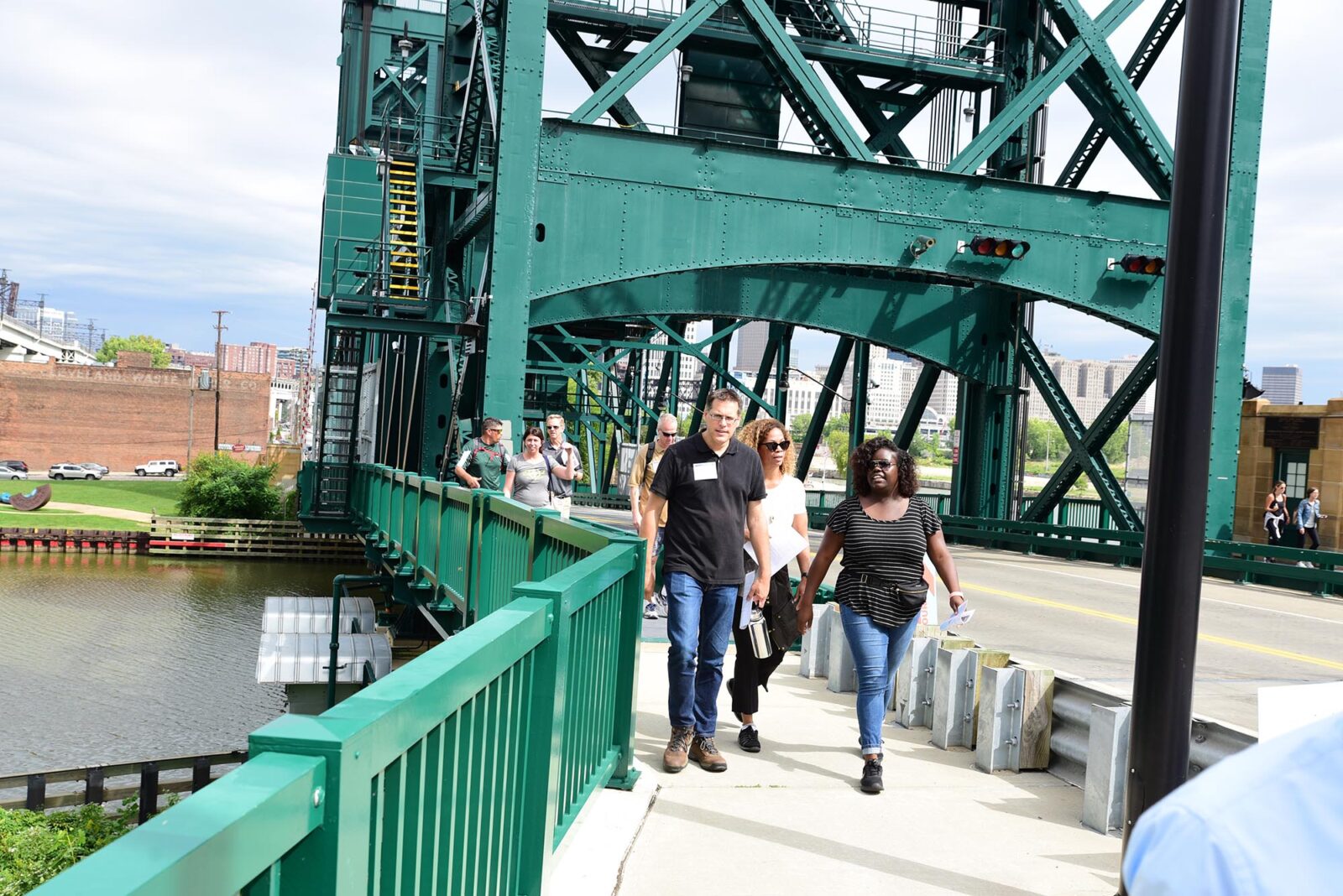 Park Study Tour attendees walking across a green bridge