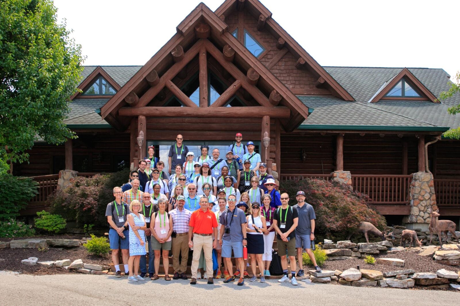 Park Study Tour attendees posing in front of a log building