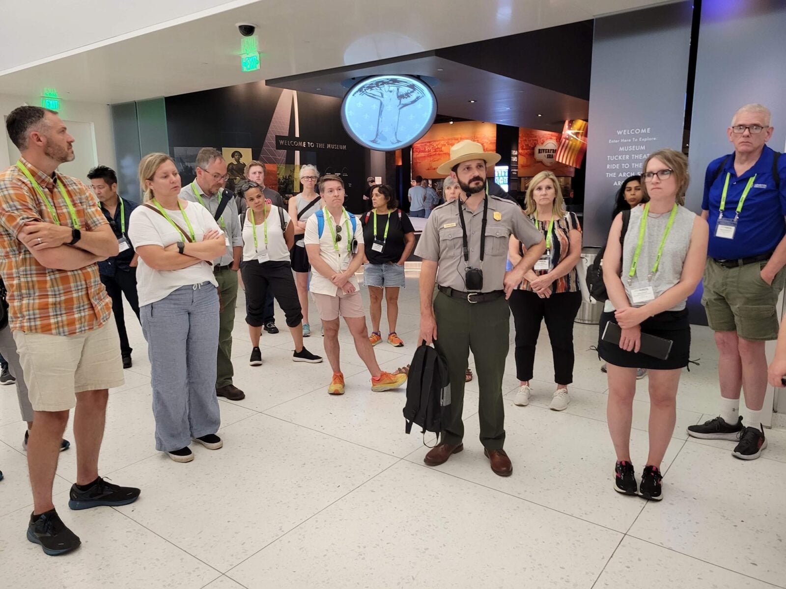 Park Study Tour attendees listening to a ranger in a museum